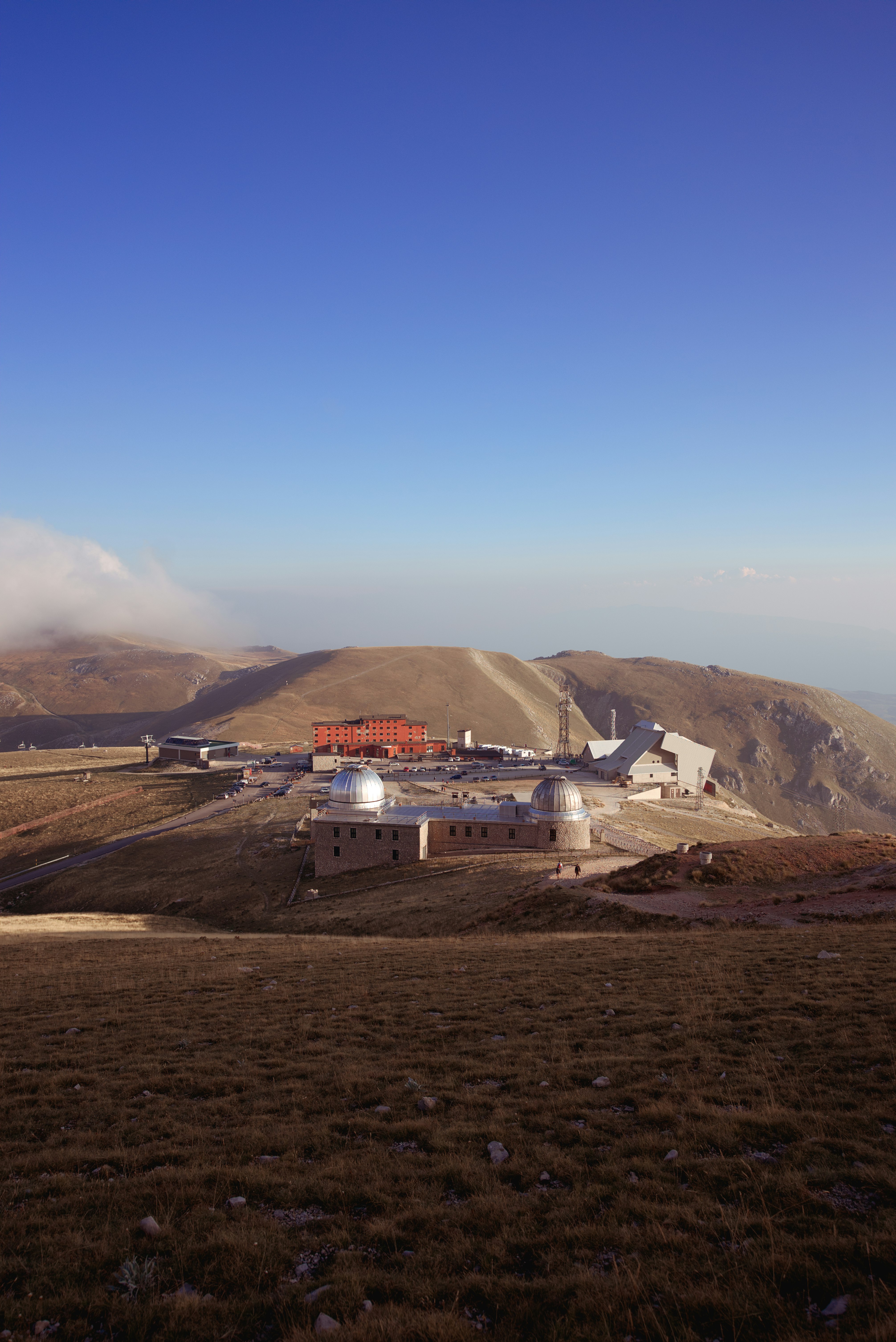 white and red building on top of mountain during daytime